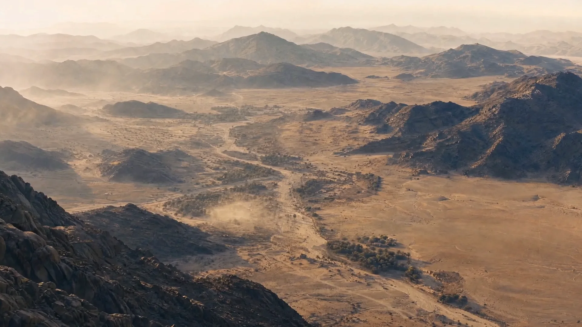 Aerial view of desert ridges in low golden light
